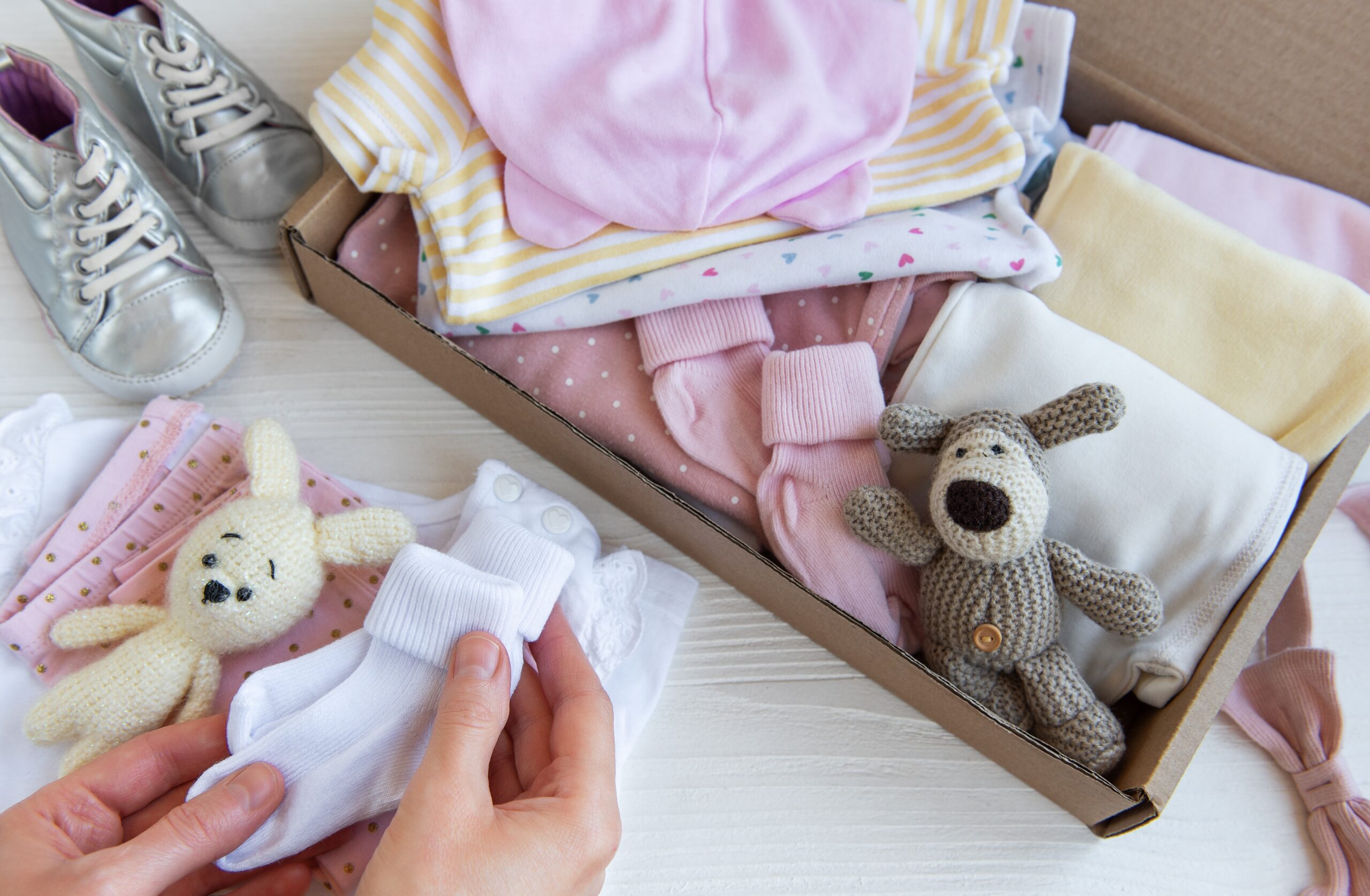 Woman putting children's clothes into a box