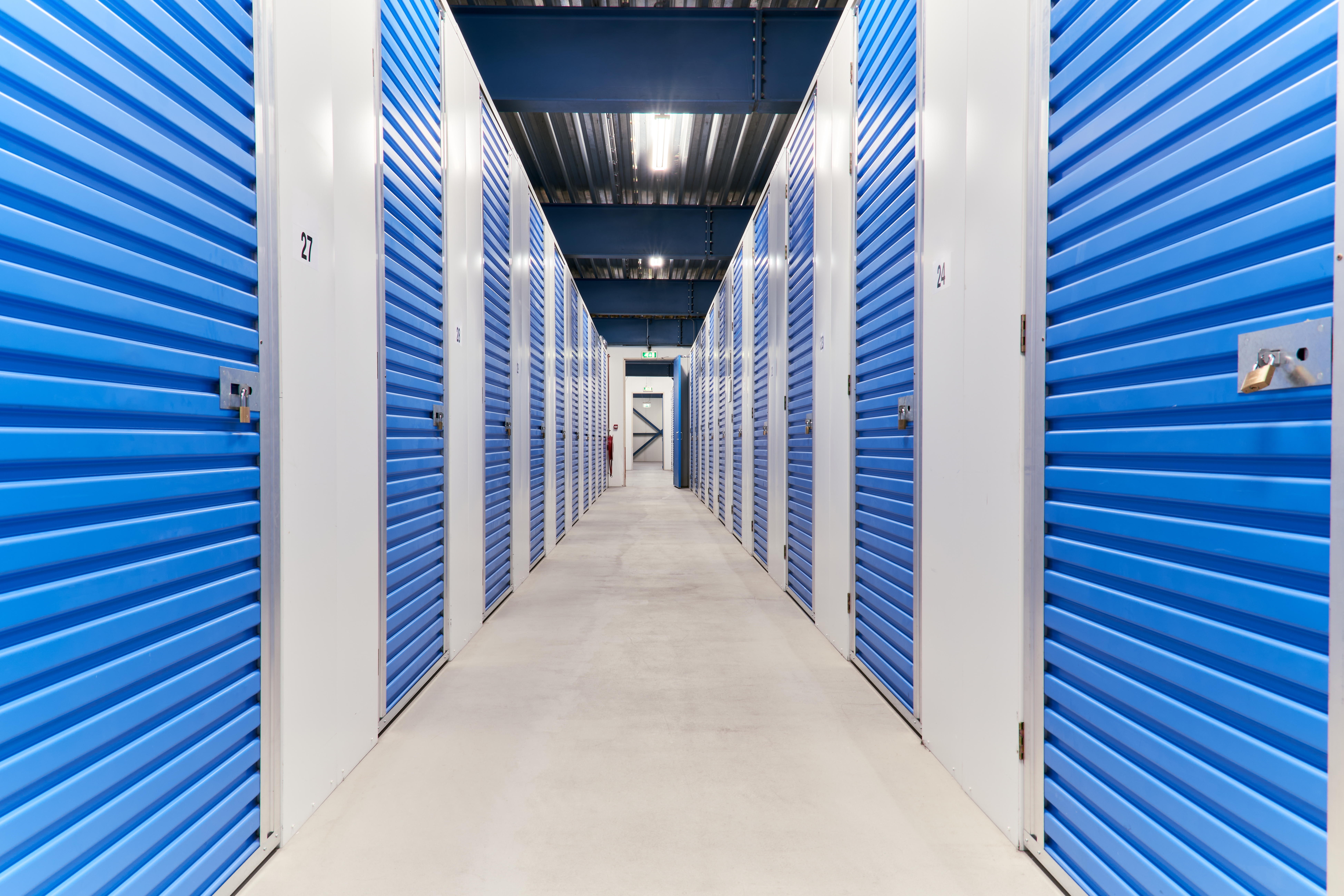 a hallway of first-floor storage units located indoors