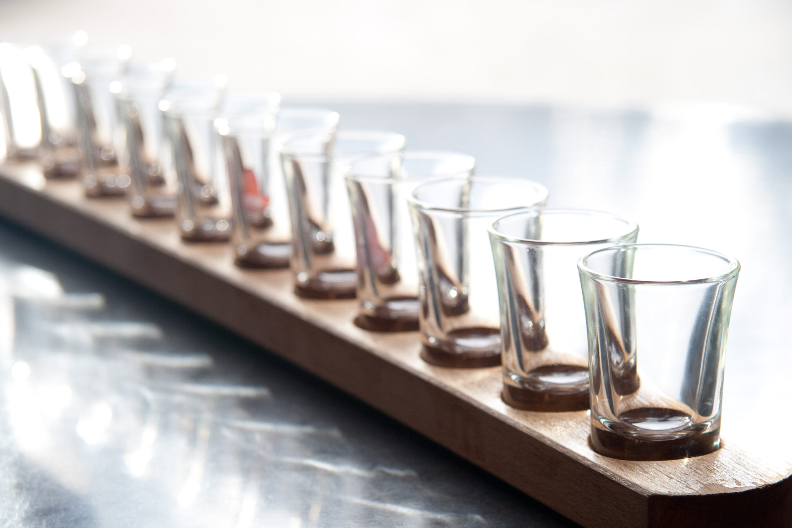 a row of empty shot glasses on a tray