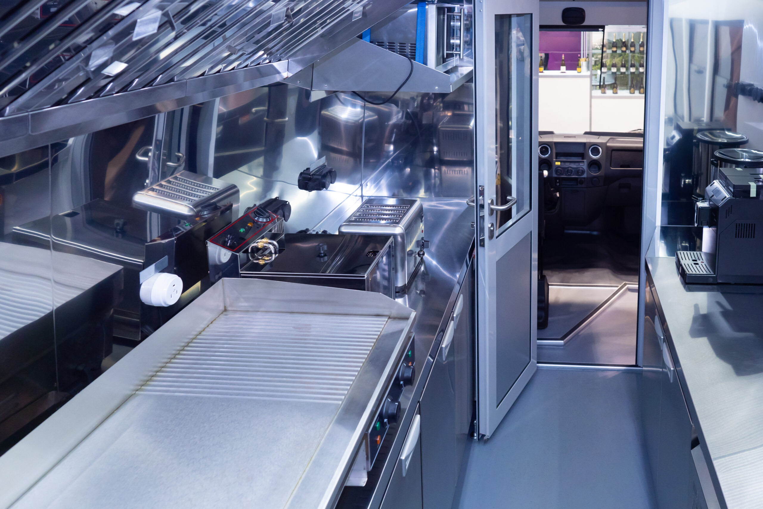 Inside of a food truck with stoves and kitchen appliances