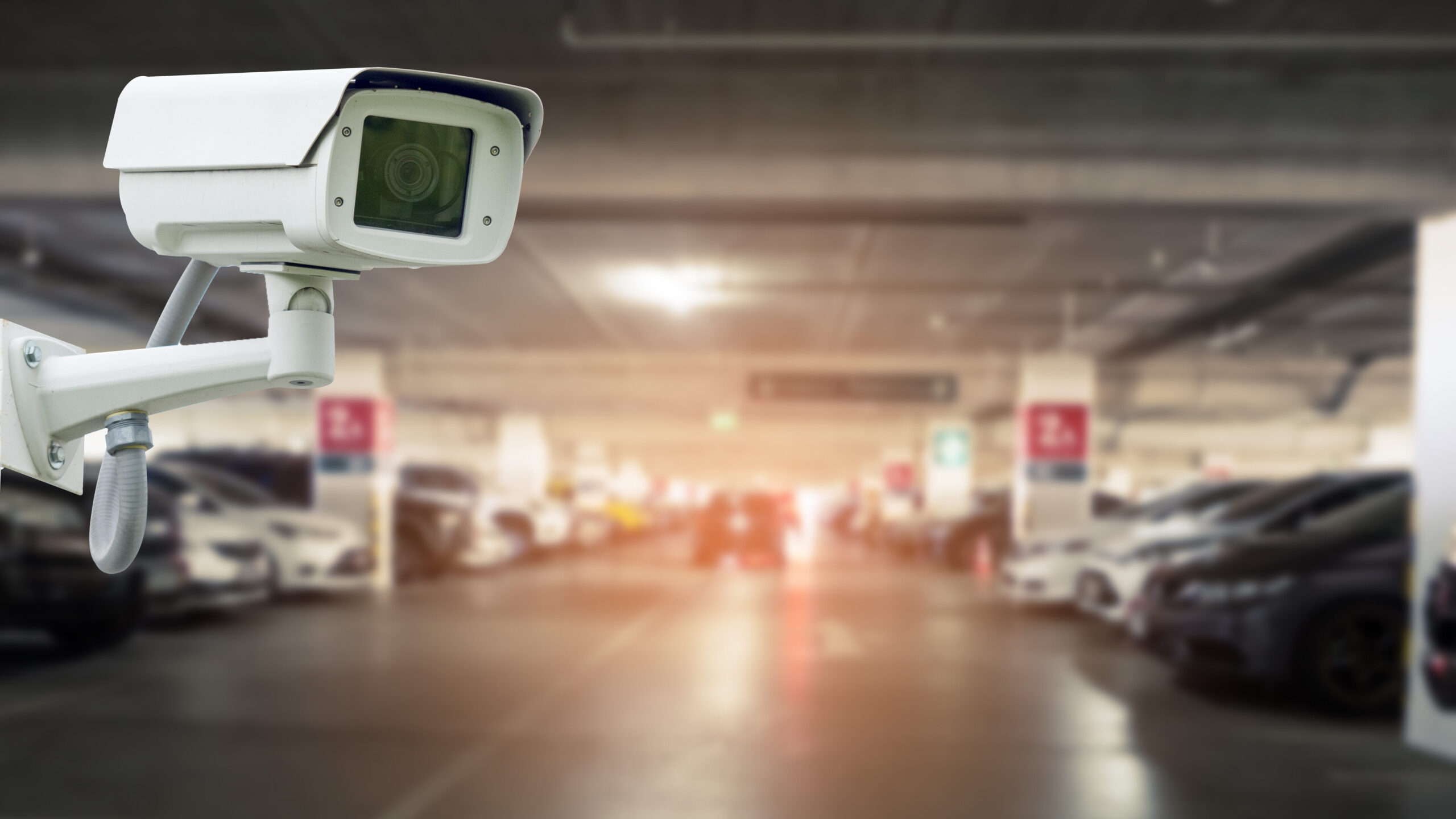 a surveillance camera inside an indoor parking lot