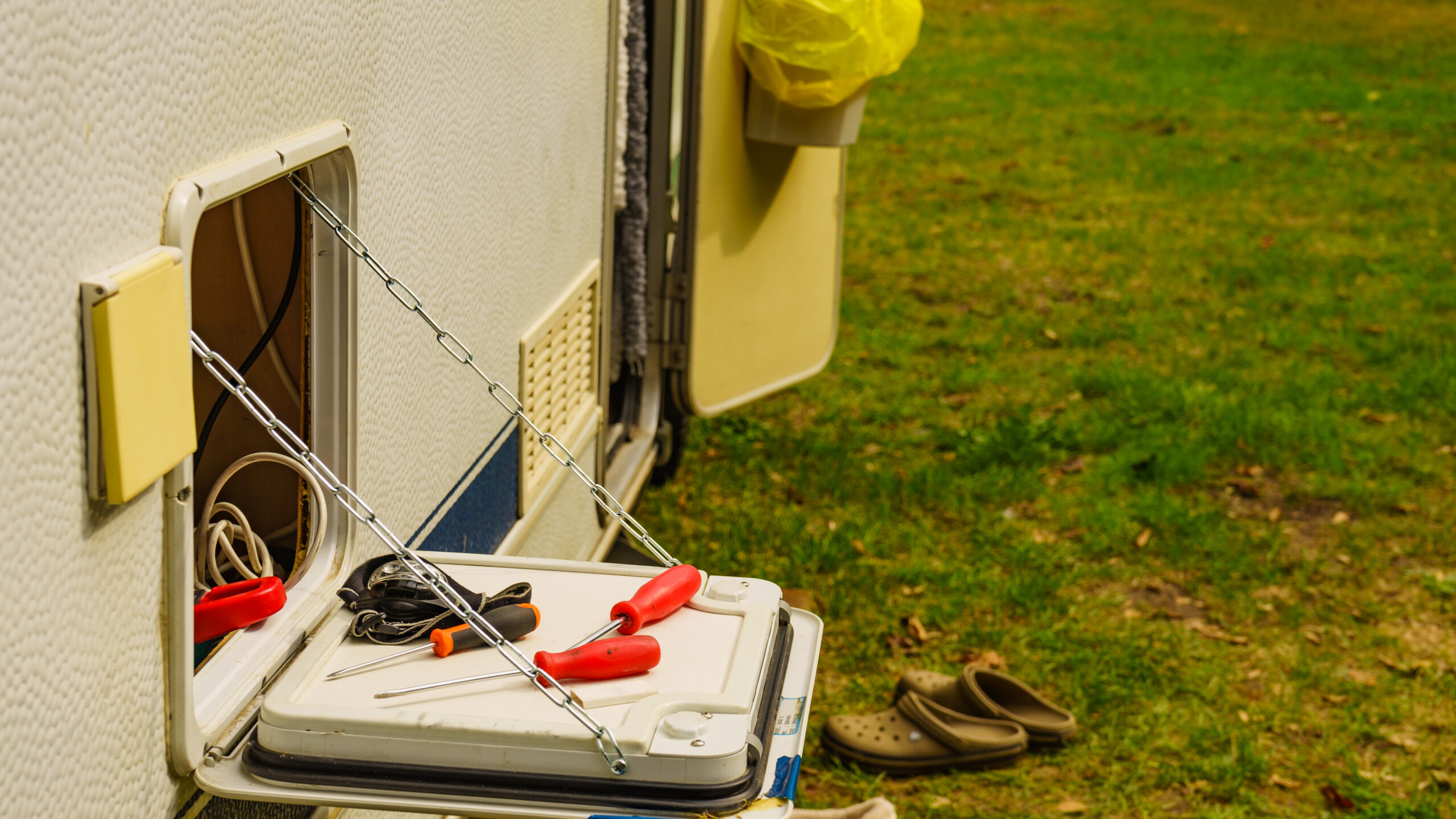 tools stored on the side of an RV