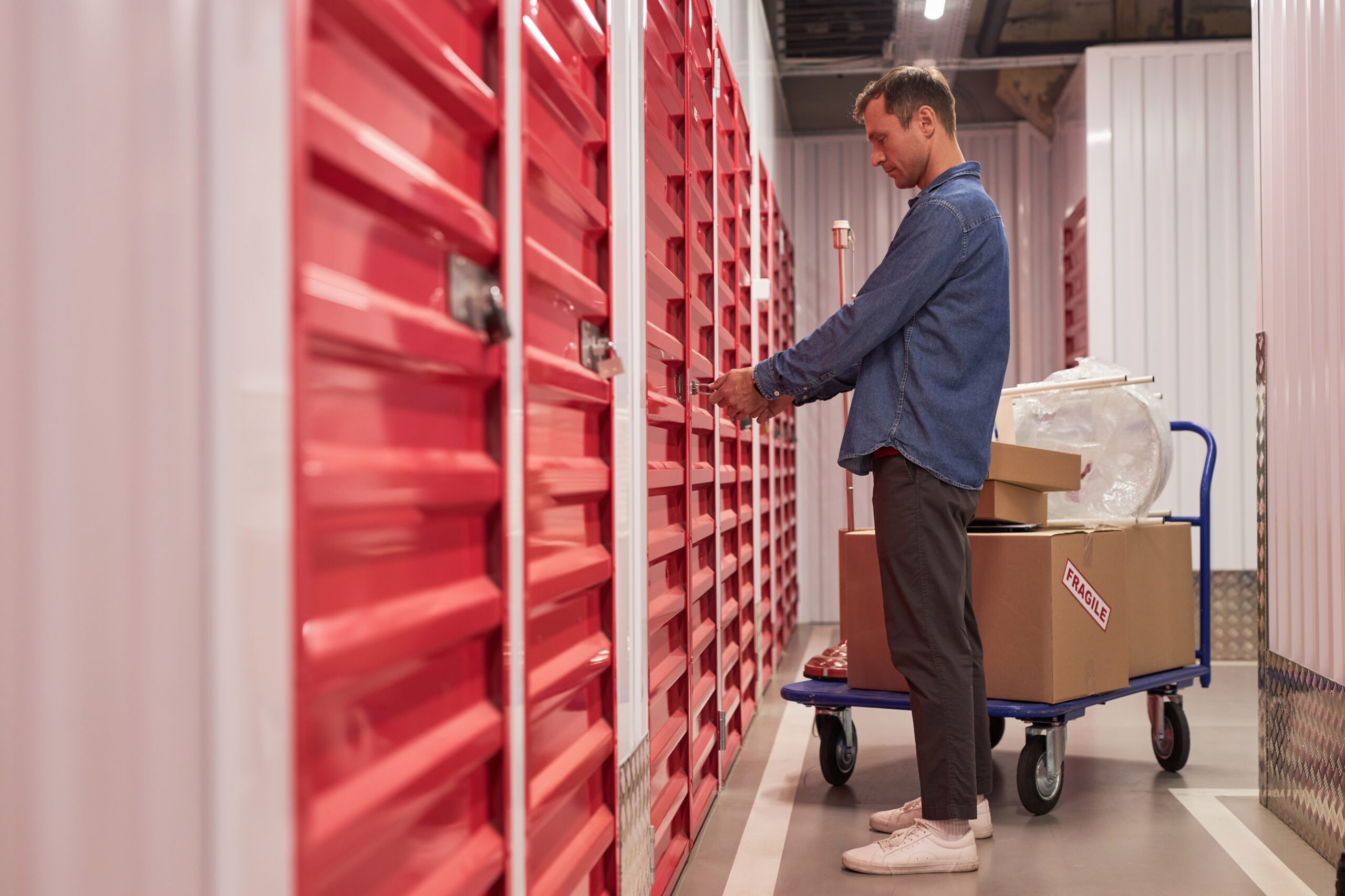 man unlocking the door to a storage locker