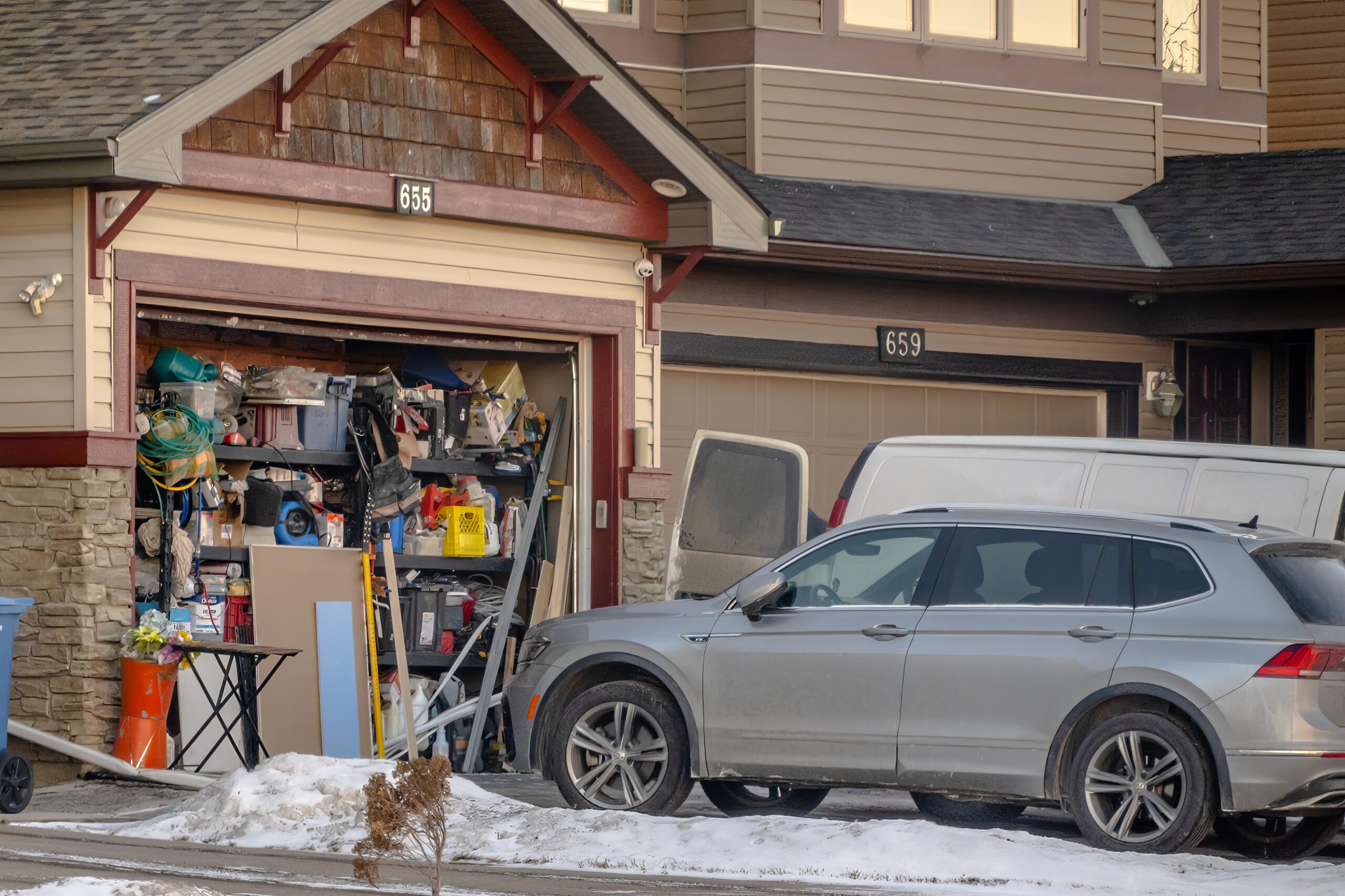 car parked in front of a full garage
