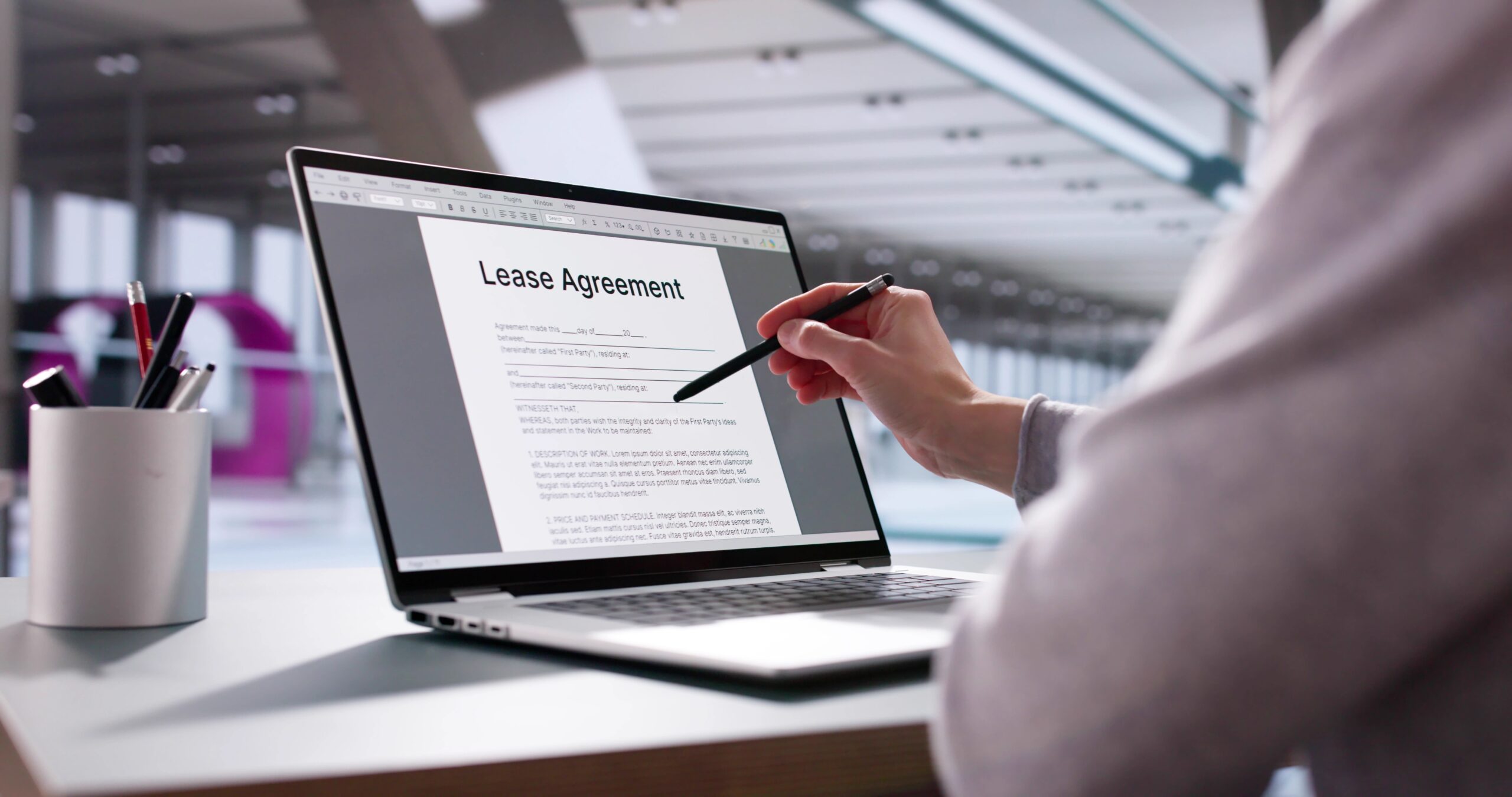 person reviewing a lease on their laptop