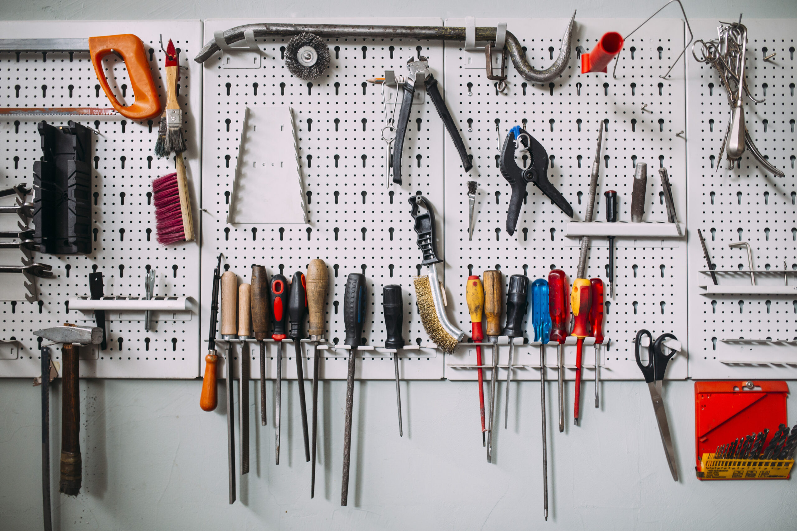 a variety of hand tools mounted on a wall