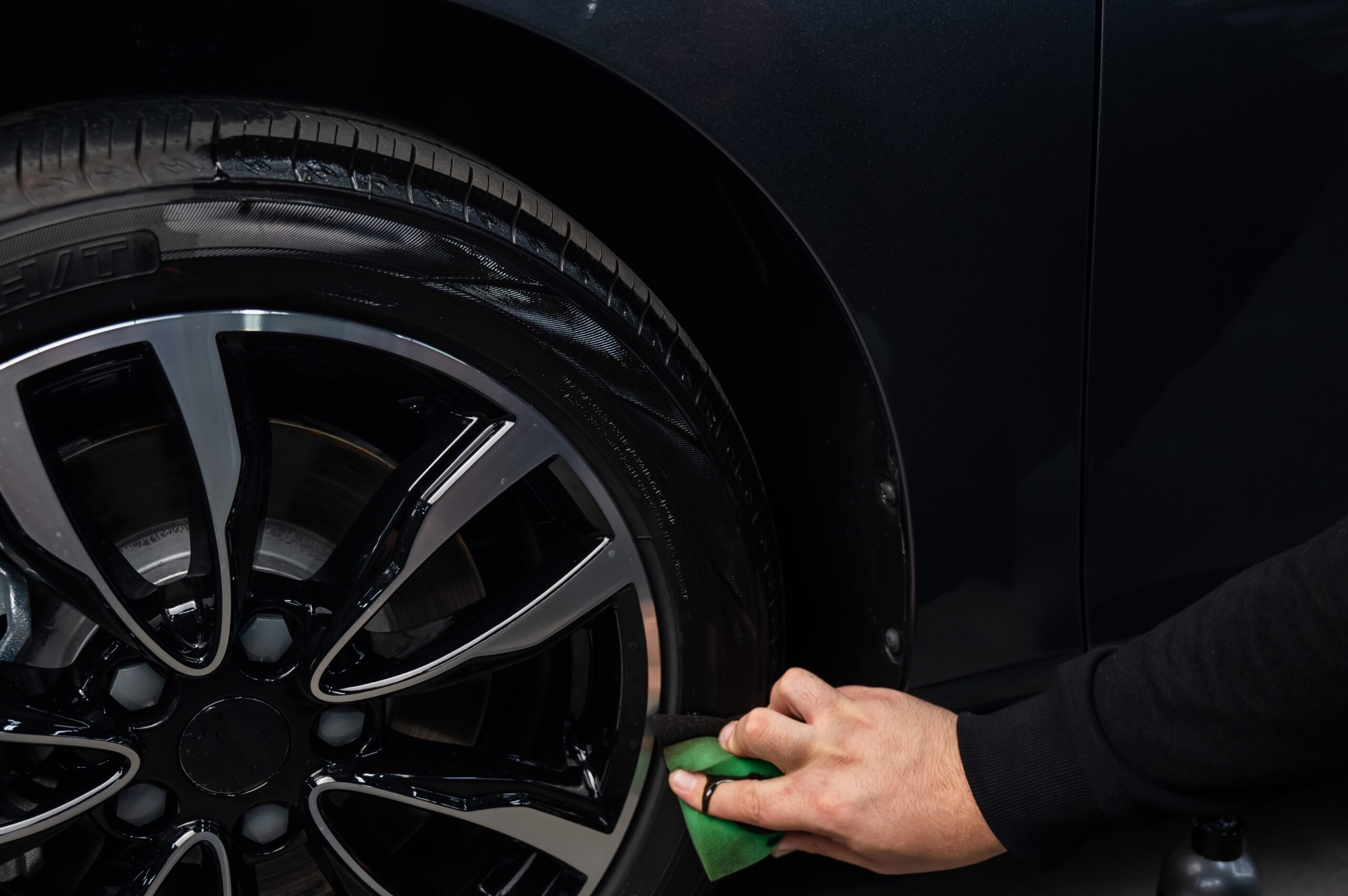 close up of person cleaning a tire